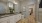 bathroom with a large mirror and walk-in closet